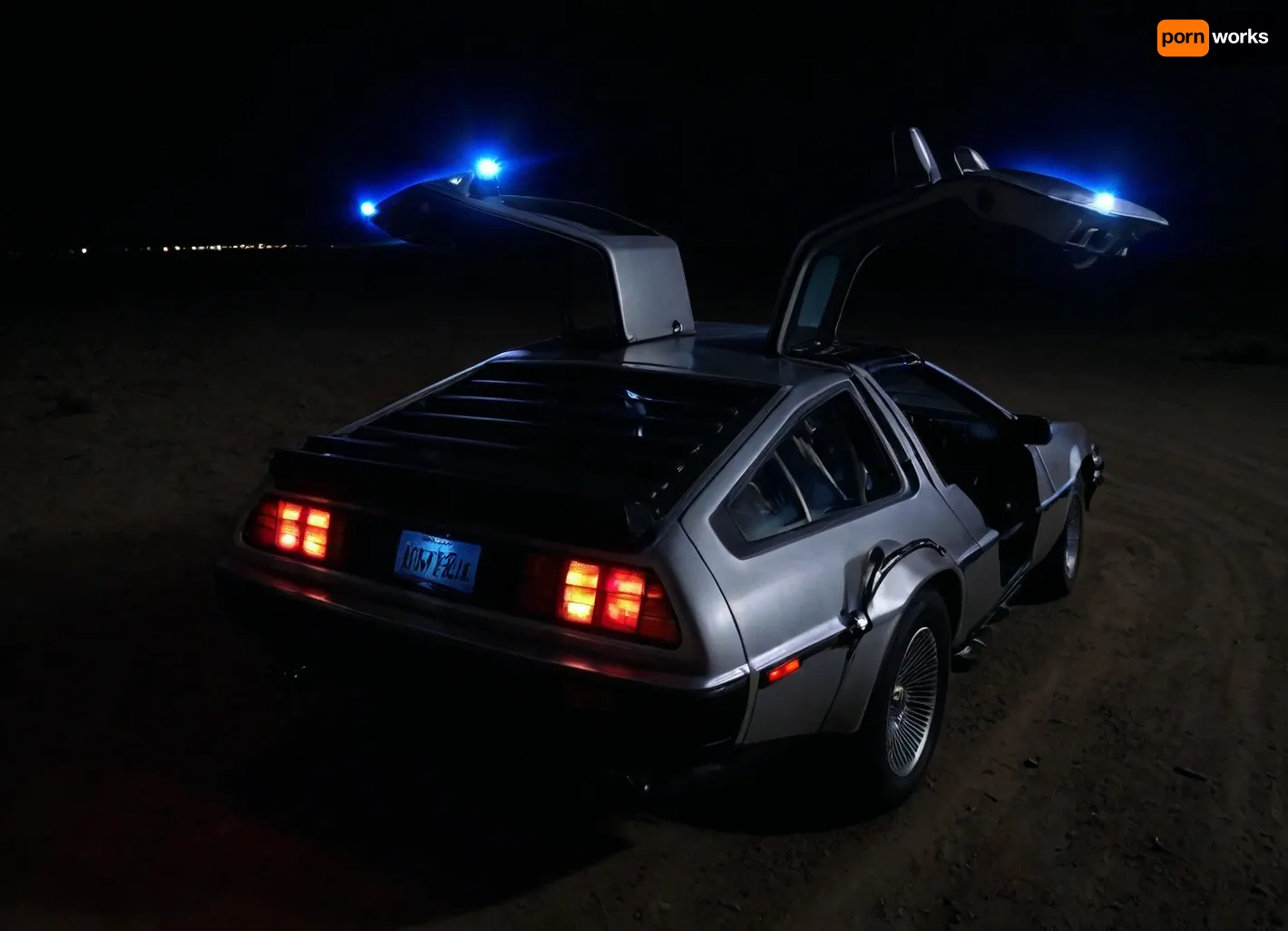 DeLorean from BTTF, (Back to the Future), Night, Dark Sky, Road in Desert, Real Road, Lights of DeLorean, (Travel Time Effects, Driving to 88mph, Blue Lights on Components Located on the Wings of the DeLorean, Blue Flash, Blue Flashes from the DeLorean), Marty McFly Sits in the DeLorean and Drives it, Side View from Above, <lora:dark:.5>