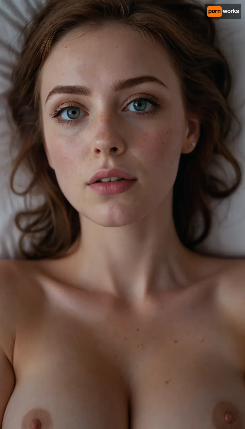 18 Year old woman, (Irish, pale skin, freckles, freckles on face), (photorealistic, photo realistic, photorealism, photo realism), (hyper realistic), hyperrealism, (ultra realistic), (8k resolution), (ultra-detailed, insane detail), (professional photography), (masterpiece, best quality, ultra quality, highest quality), (perfect lighting, perfect illumination, ring lighting), (same color eyes, symmetric eyes, matching eyes, detailed eyes, detailed iris, detailed pupils, limbal ring around iris, perfectly round iris), (detailed skin, high detailed skin, intricately detailed skin, perfectly detailed skin, high quality skin, highest quality skin, exquisitely textured skin), (intricate clothing, detailed clothing), (microblade eyebrows), (long eyelashes with mascara), (overfilled lips, juicy lips, filled lips, puffy lips, glossy lips, her thick wet lips are slightly parted, nervously biting lower lip, lip bite, lip biting), (flushed cheeks, flushed neck, blushing cheeks, blushing neck), (casual makeup, subtle makeup, natural makeup), (narrow jaw, delicate jawline, pointed jaw and chin, heart shaped face, pixie face, fairy face, fae features, extremely feminine face, round face, chin, mouth, high cheekbones, sharp cheekbones, faint vellus hairs), (upturned button nose, upturned nose, delicate nose, nose), (hair, pixie cut hair, pixie hair, loose hair framing her face, messy hair, tousled hair, bed hair, sex hair, dark ginger hair with dark roots), (eyes slightly crossed, big eyes, wide eyes, doe eyes, slightly wide set eyes), (pale grey eyes, pale green eyes, striking eyes, captivating eyes, mesmerizing eyes, fae eyes), (huge breasts, large breasts, large natural breasts), (laying on back, laying down, lying on her back so her big soft tits ride up towards her face), (athletic body, sporty body, lean body), (close up portrait of face, tight closeup of face, closely zoomed in on face, tight in on face, extreme closeup), (looking straight into the camera, looking straight ahead, head slightly raised, gazing lovingly straight into the camera, looking down on her from above), (she's in love, adoring gaze), (no nudes, nonnude), (relaxed posture, casual pose), (loving expressing, adoring expression, joyous, joyful, pleased), (girlfriend, girlfriend material, girlfriend experience), <lora:FLUX_winks_and_biting_v2:.5>