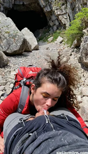 A 21 year old woman, (lying face down), on the rocky floor deep inside a dark cave, sleeping deeply after finding refuge from a storm. Next to her lies a well-worn red hiking backpack with visible straps and pockets, showing signs of a rugged journey. She is dressed in outdoor gear, a lightweight, weathered jacket, hiking pants, and sturdy hiking boots, with subtle dirt and scuff marks that reflect her recent struggle through harsh conditions. Her Clothes are partly off or pulled down. A huge cum load has been dumped on her face during her deep sleep, The cave interior is dim and textured with jagged rocks, while soft beams of sunlight filter through cracks, highlighting the dust particles in the air and casting a faint glow on her gear. A huge cum load has been dumped on her face in her deep sleep. In the distance, the cave exit glows brightly, revealing a sunny, vibrant landscape of greenery and blue skies outside, contrasting the cave’s dark safety with the inviting brightness beyond. Photorealistic, perfectly detailed face, ((submissive)), ((lovely)), (((wild hair with sidelocks))), (((full body view))), (((high detailed legs))), (((high detailed fingers))), ((very much want have sex)), (love juice:1.4), ((high detailed pores on skin)), well-build body, medium tits, small lips, lots of freckles face and skin, blush on the checks and nose, (raised nasal tip, upturned button nose, upturned nose, delicate nose, nose), hypnotized loving yellow brown eyes