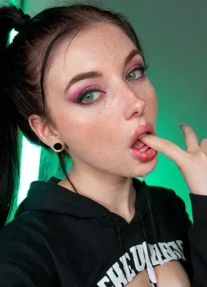 Breathtaking, very horny, extremely junior 19 year old American Goth girl, medium fake breasts out, athletic body, perfect skinny body sharp nose, smooth silky long hair rectangular face, wide mouth, full lips, dark makeup, black hair and pale skin, tattooed, expensive hairstyle, expensive earrings, beautiful necklace, thin eyes, green eyes, pale skin, freckles, big cheekbones, slim, deep dimples, cute chin, kind eyes, white teeth, detailed faces, <lora:SDXL_BetterFaces-LoRA_v1:.5>, Black eyeliner. Heavy bronze eyeshadow. BREAK
Fully clothed in, (hot pink baggy college hoodie:1.2), . realistic eyes. she suggestively has her finger in her mouth. Sultry expression. Tousled, high ponytail. Eye contact, (sultry), confident. Petite, athletic, sweaty. Photorealistic. Viewer at eye level, close up. In a poorly lit, rundown basement of a derelict building. Close up, macro shot, Canon RF 100mm F2.8L Macro IS USM, Kodak Portra 400 color film. Nostalgic, film-grain aesthetic., with an overall underexposure of 1-2 stops to accentuate the darkness and isolation of the environment. Close-up on face. Soft backlight.