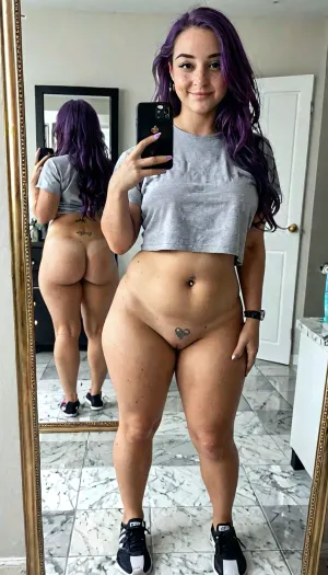 ((Plump scandinavian 20 year old girl, freckles, 5'2", purple hair, long hair, small/medium chest, 36c, pierced nipples, shaved pussy, straight hipsh pawg)), bulging pubic mound, plump pubis, ((sensual face), grey yoga shorts, tee shirts, taking a selfie, full body, in the bathroom mirror, mirror behind showing back side, covered pussy), view from behind