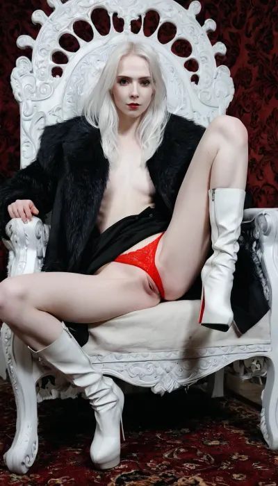 1girl, white hair, proud woman, proud look, predatory look, pale skin, thin features, long legs, sitting on a throne, leg on leg, sexy red panties, long white boots, black open coat visible, <lora:detailed_notrigger:.8>