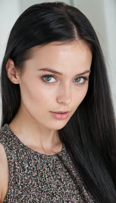 A very detailed and realistic portrait of a young woman with an intelligent yet attractive appearance. She has a delicate face, smooth fair skin and long straight black hair. Her expressive eyes are calm, giving her a sophisticated and diligent look.