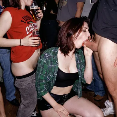 introvert grunge girl at college party in 1992, fully clothed, drinking beer