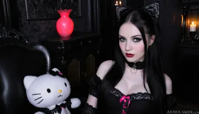 Goth Mexican girl, pale skin, slender build, long raven hair with silver streaks, dramatic dark eye makeup, cradling neon pink plush Hello Kitty, lounging in a dimly lit Victorian-style parlor filled with antique furniture and occult symbols, flickering candlelight, intense gaze meeting the viewer, close-up shot, high contrast black and white style, fine art photography texture, <lora:Sweaty_Realism_4-000006:1.9>, <lora:Collar-SDXL:1.9>