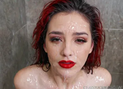 very cute and beautiful classy young woman, face covered in semen and cum . Black haired . Red lips . Wet haired