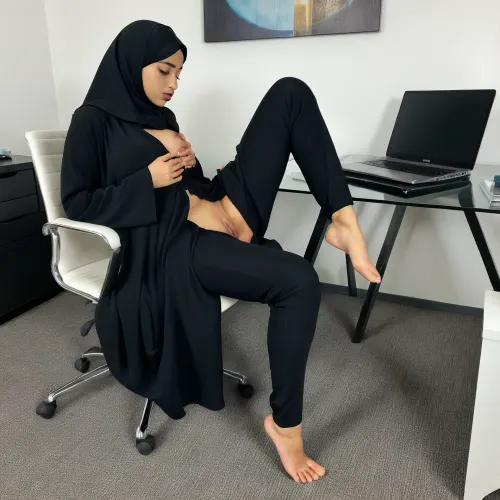 A photo of a foot massage being given to naked arab muslim woman in black hijab and Abaya showcases her bare feet while she is sitting on a chair in a modern office, working on her laptop., (Office), (muslim), (hijab), (abaya), (pussy), (barefoot)