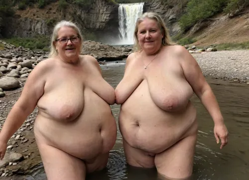Two sexy beautiful elderly fat Lisbian women swim together in a mountain river, naked, waterfall, spray, rainbow over, megachubsdxl, morbidly, obese, sagging, breasts, stretch, marks, <lora:megachubsdxl_13:.5>, <lora:sagging-000015:.5>, <lora:stretch_marks:.5>