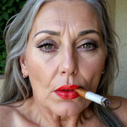 A 50-year-old European woman with big tits and a flat stomach is smoking a cigarette while enjoying an orgasm expression on her face