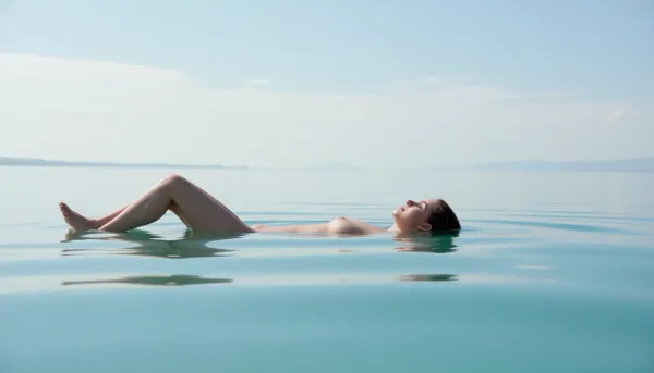 Eine Frau in einer ruhigen und friedlichen Reflexion, mit einer beruhigenden Atmosphäre und minimalistischen Hintergrund